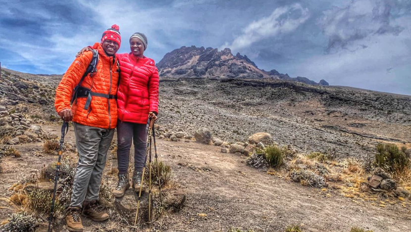 Couple trekking together on the high slopes of Mount Kilimanjaro